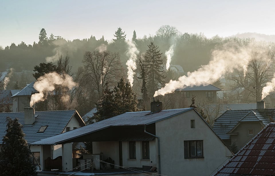 Adobe Stock image of multiple houses with smoking chimneys.