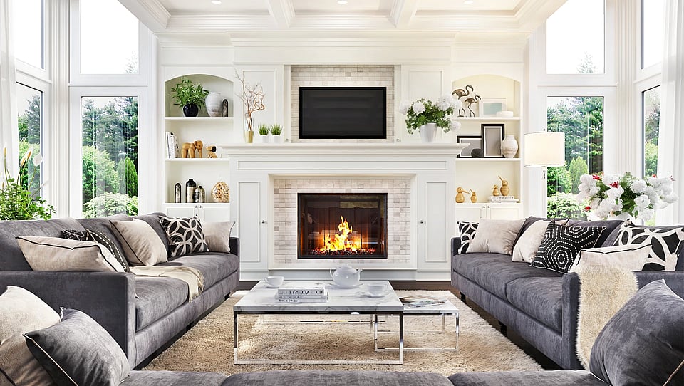 Adobe Stock image of a fireplace with a with surround in a nice living room.