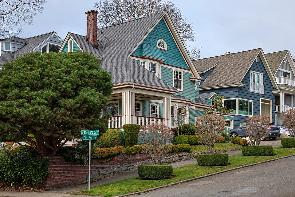 Adobe Stock image of a green home with a brick chimney.