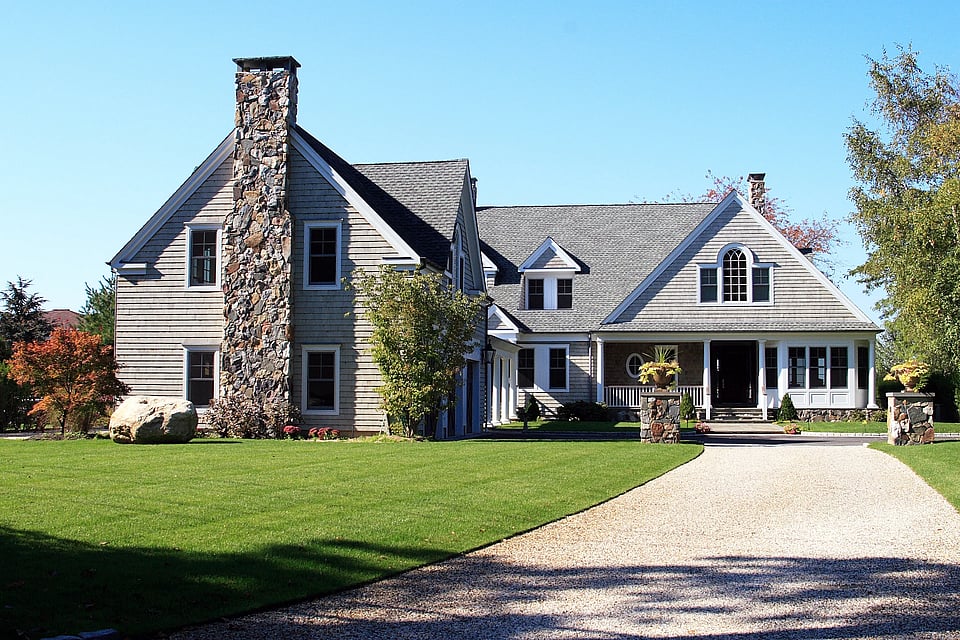 Adobe Stock image of a stone chimney on a large house.