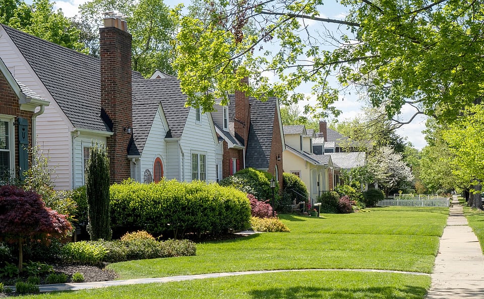 Adobe Stock image of homes with brick chimneys on a street.