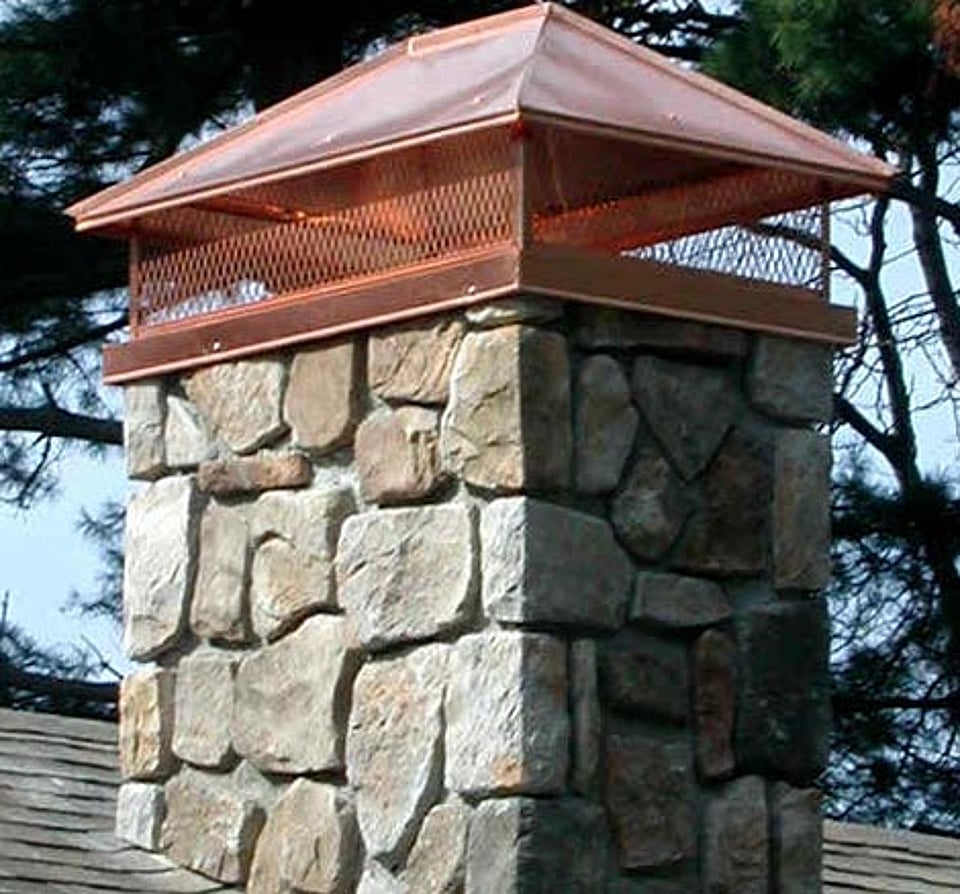 Original image of a new chimney cap on a stone chimney installed by Alpine Chimney Sweeps
