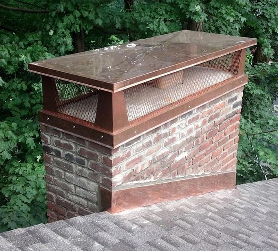 Original image of a new multi-flue chimney cap installed by Alpine Chimney Sweeps.
