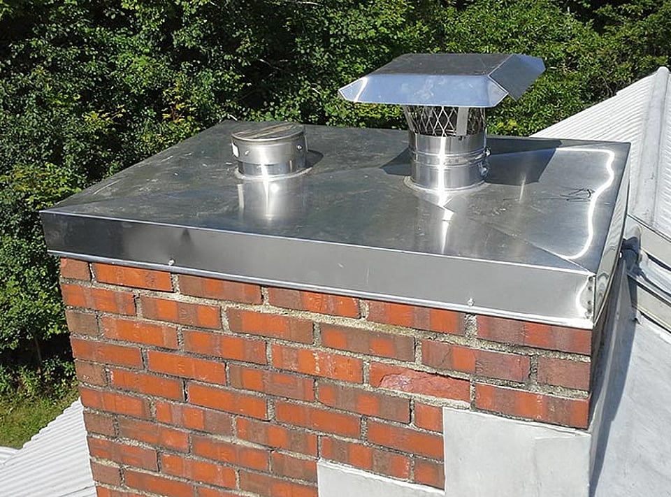 Original photo of a chimney cap and chase cover installation by Alpine Chimney Sweeps.