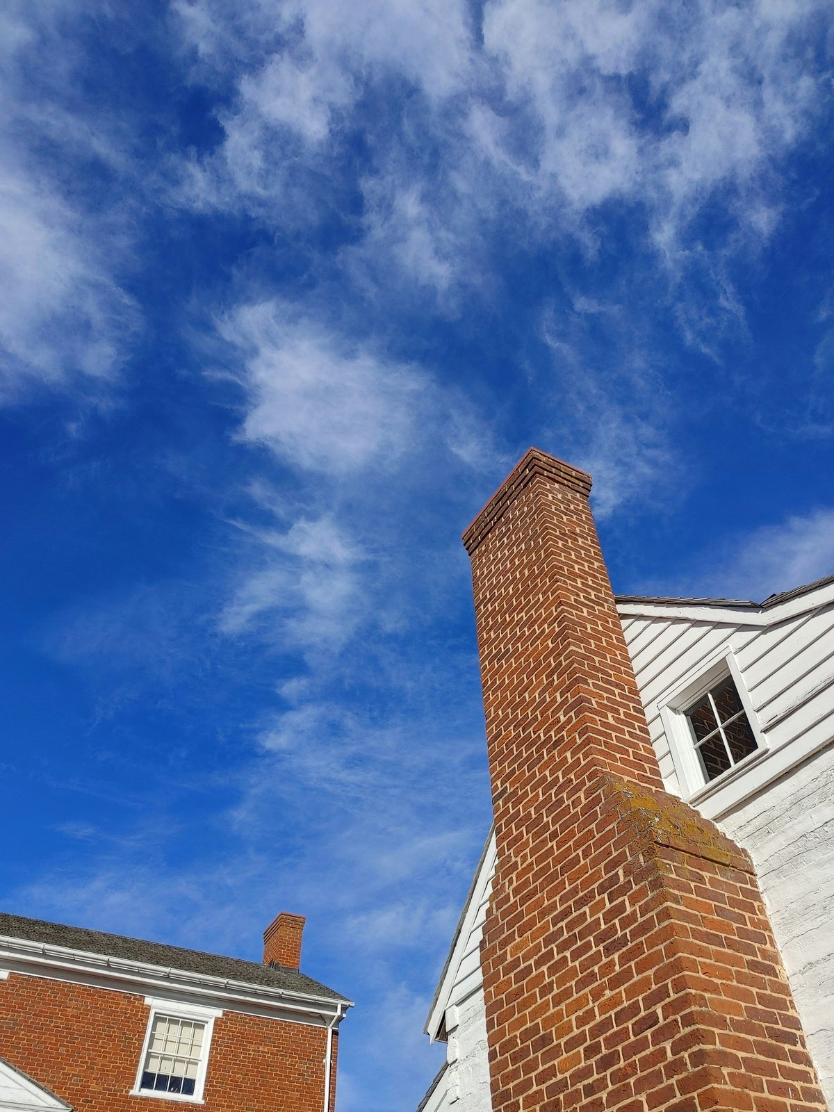 Certified chimney professional performing a thorough chimney inspection and service