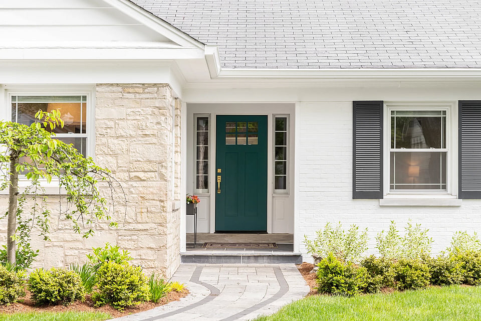Adobe Stock image of a front door with plants nearby.