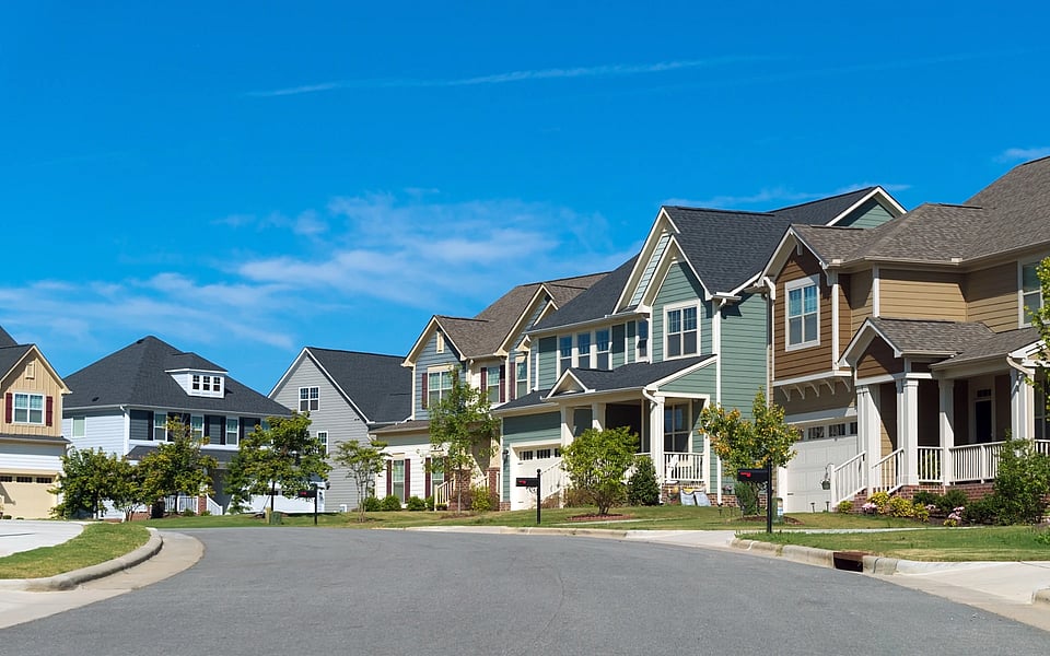 Adobe Stock image of a neighborhood street with houses.