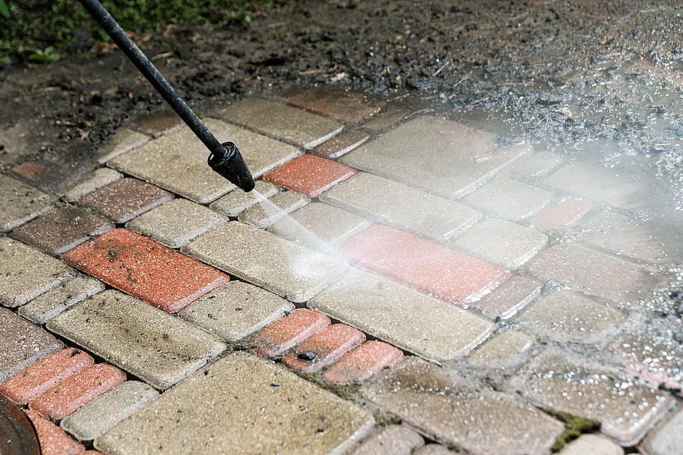 Adobe Stock image of someone soft washing a business