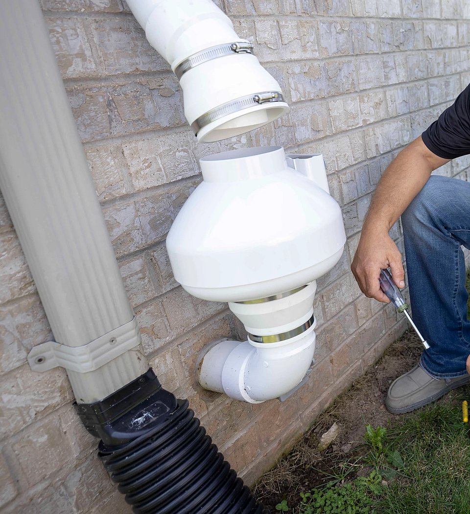 Image of a radon mitigation system fan being installed.