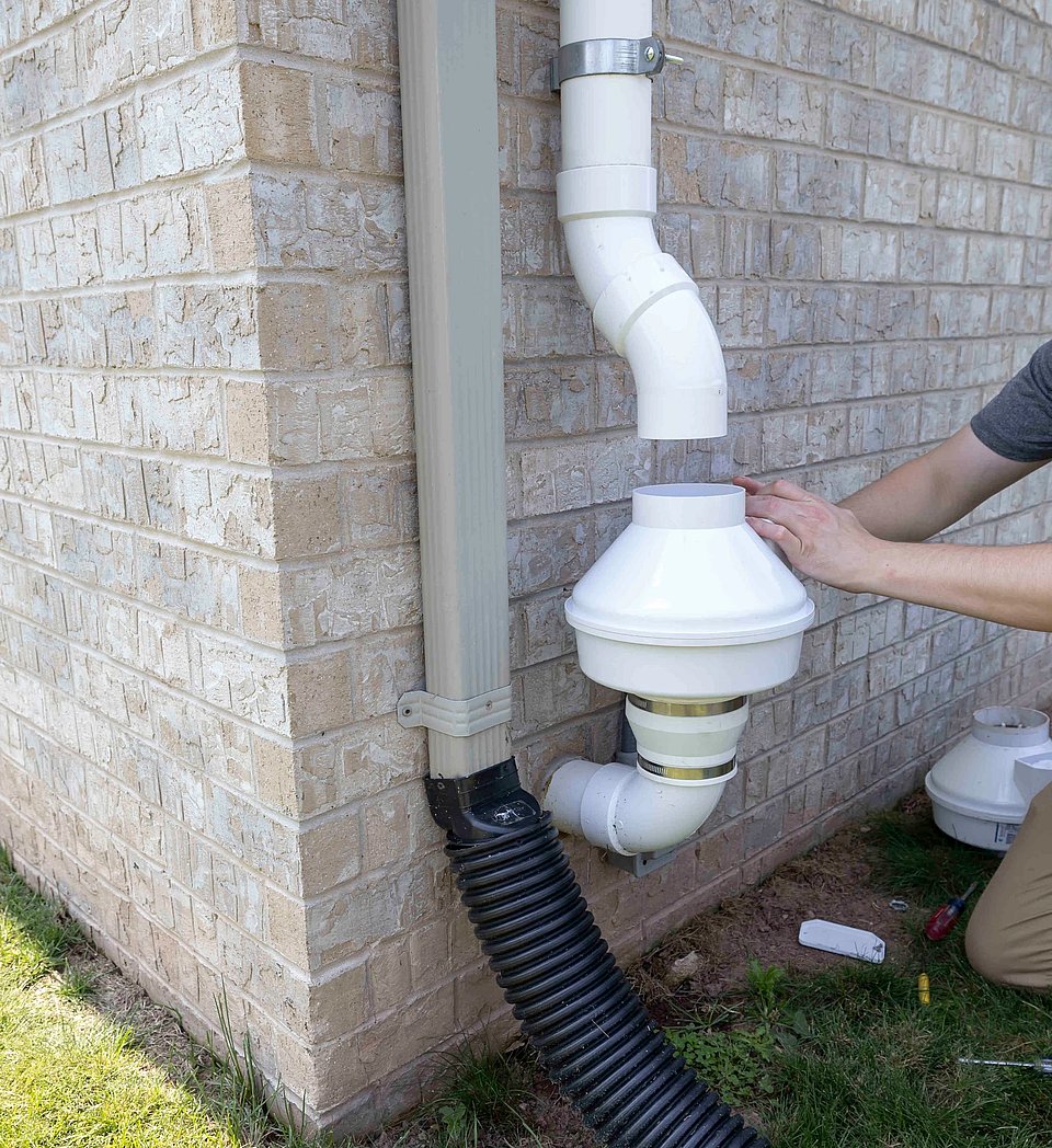 Image of a fan being replaced on a radon mitigation system.