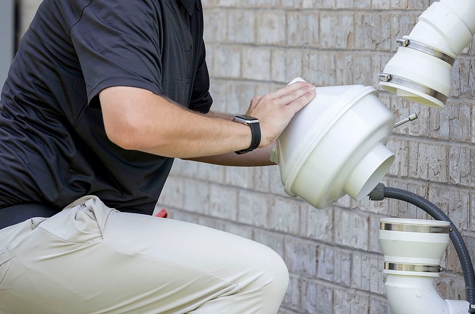 NRPP certified radon technician replacing a residential radon mitigation fan