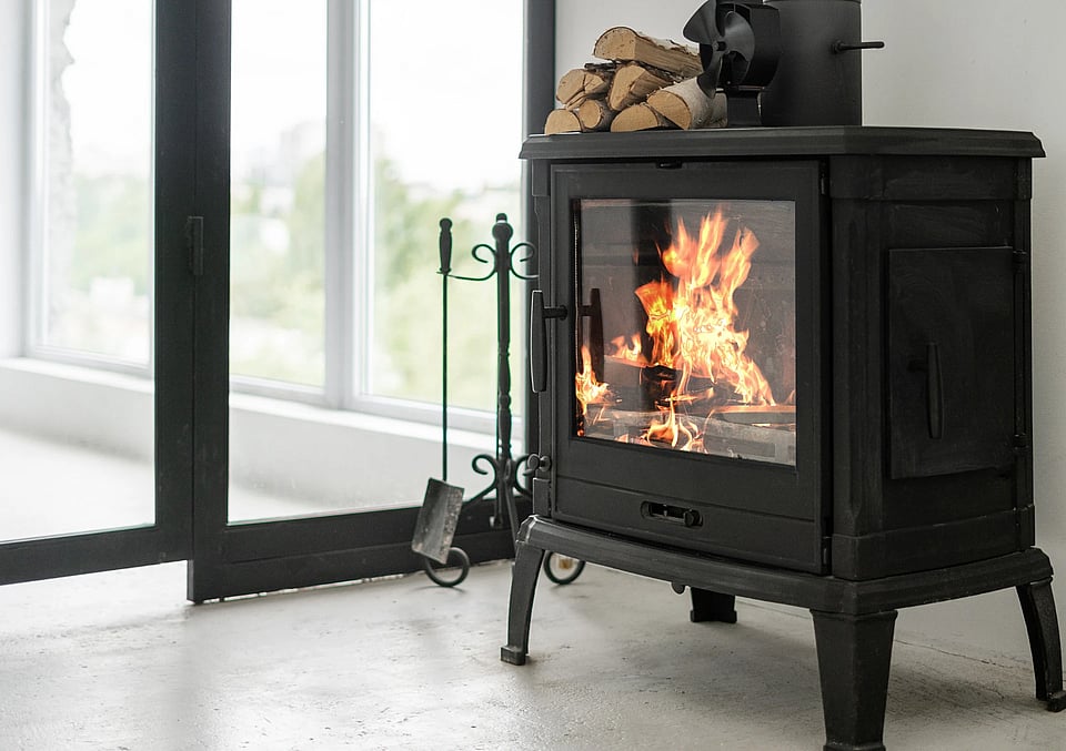Adobe Stock image of a cast iron wood stove.