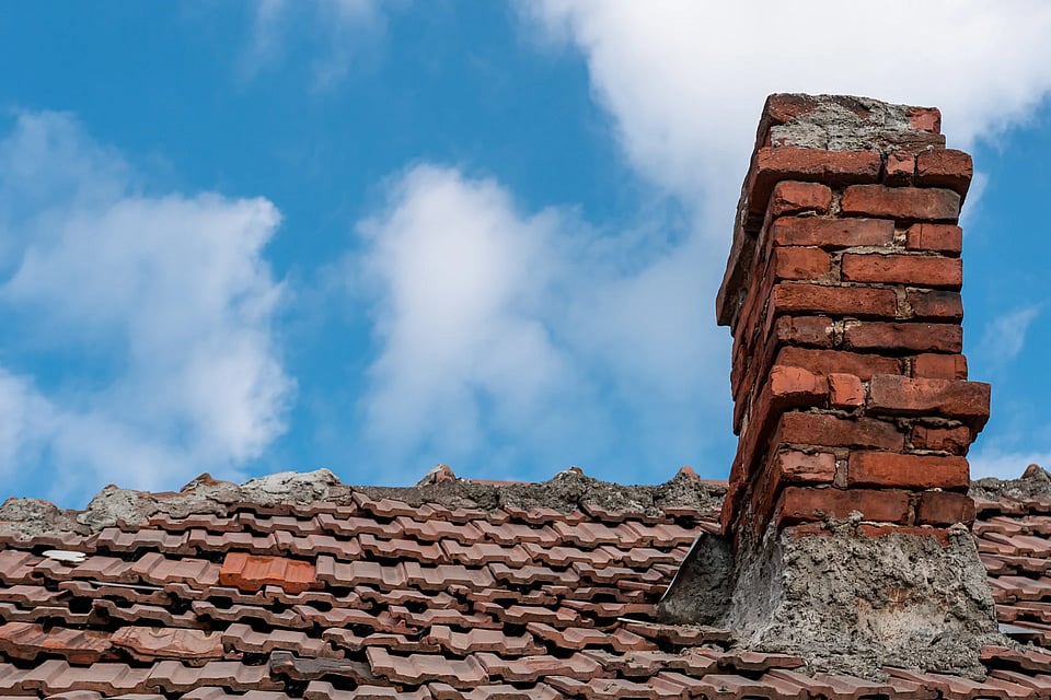 A damaged masonry chimney.