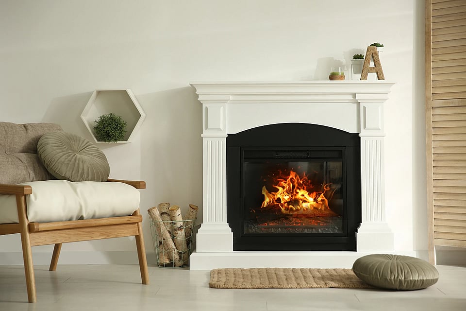Adobe Stock image of a fireplace with a white surround.
