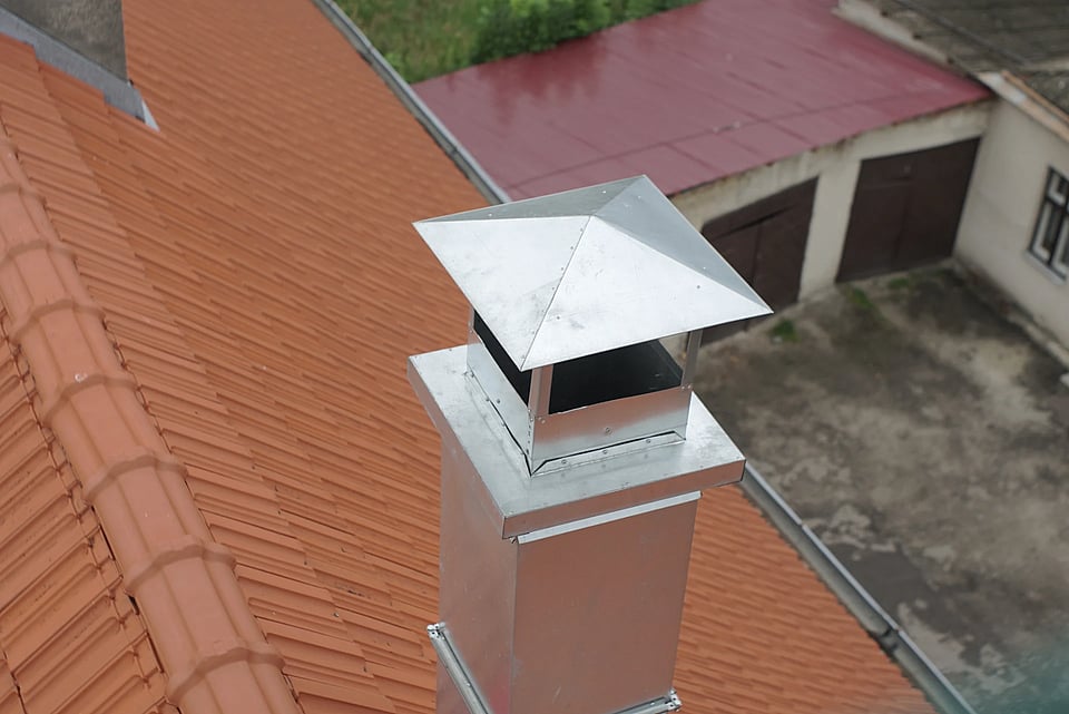 Metal chimney cap on a residential chimney