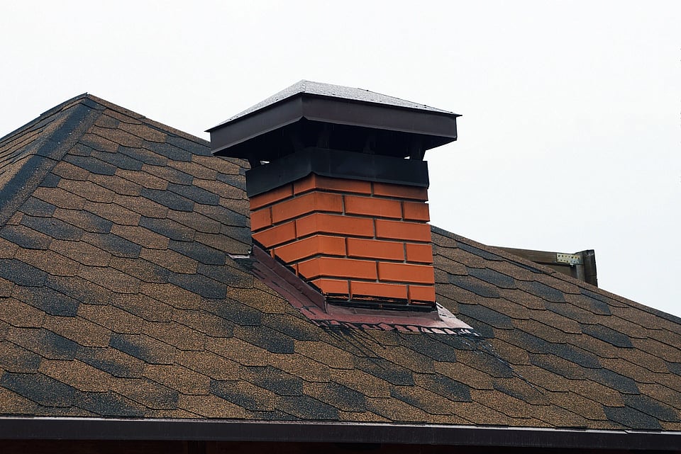 Red brick chimney with chimney cap in Pickerington, OH