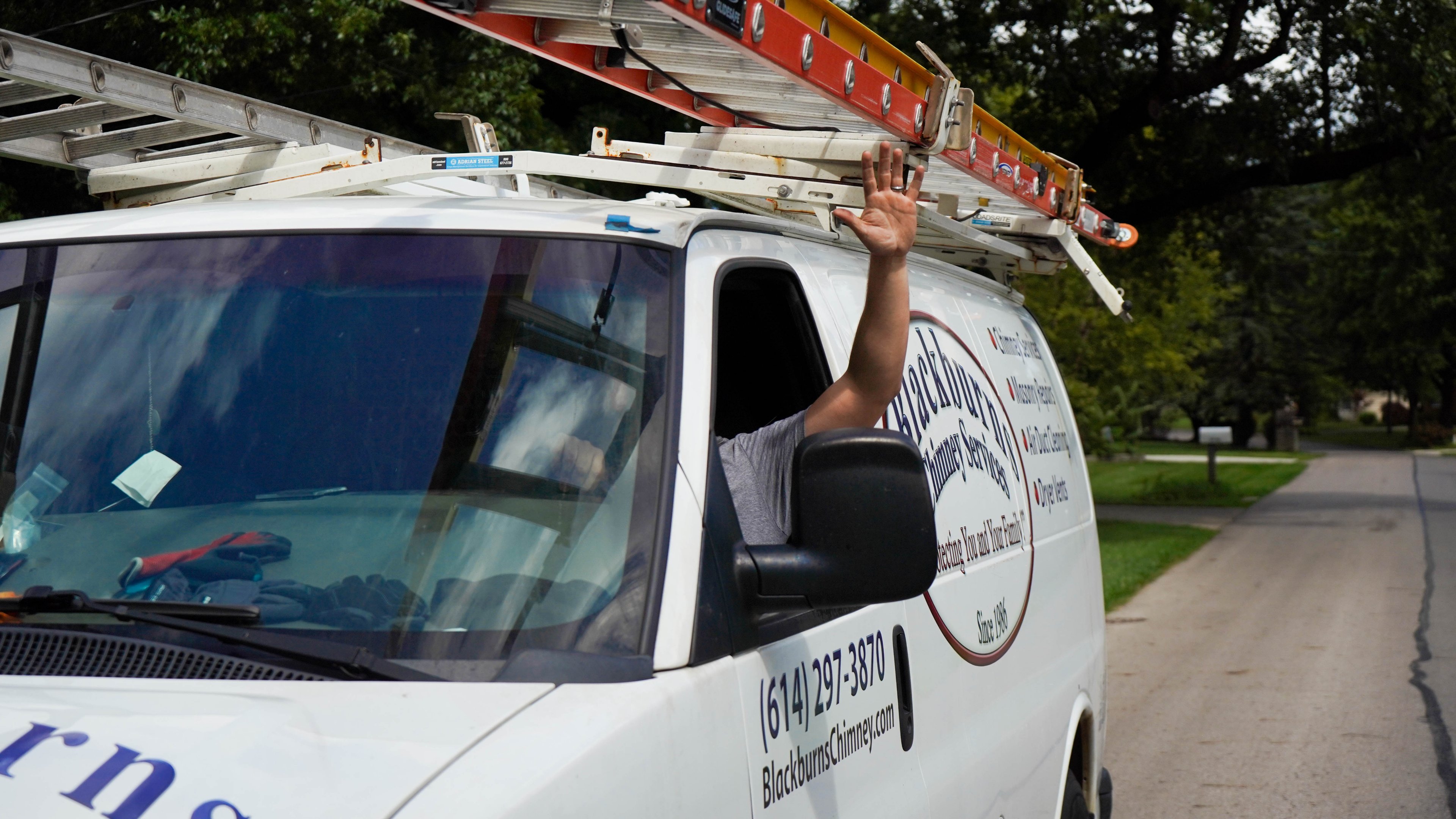 Blackburns Chimney Services technician performing a rooftop chimney sweep in Columbus, OH