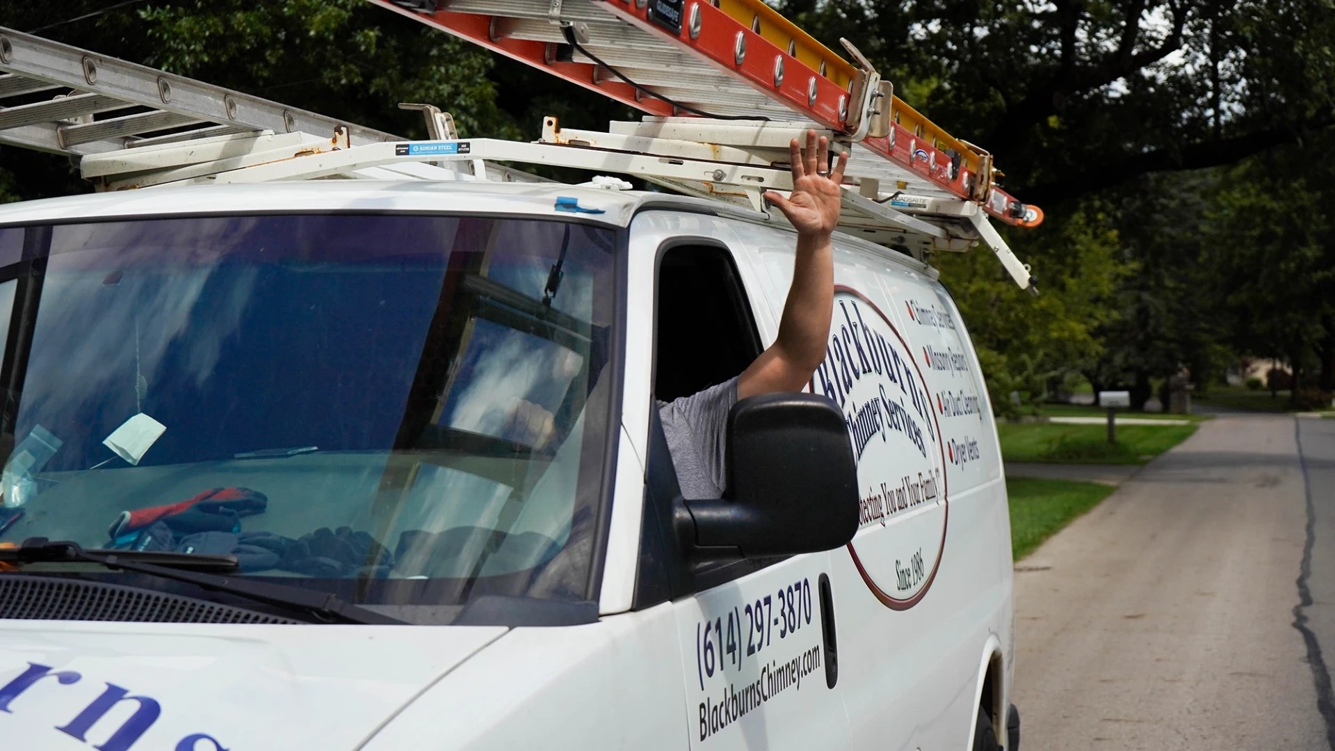 Blackburns Chimney Services technician performing a rooftop chimney sweep in Columbus, OH