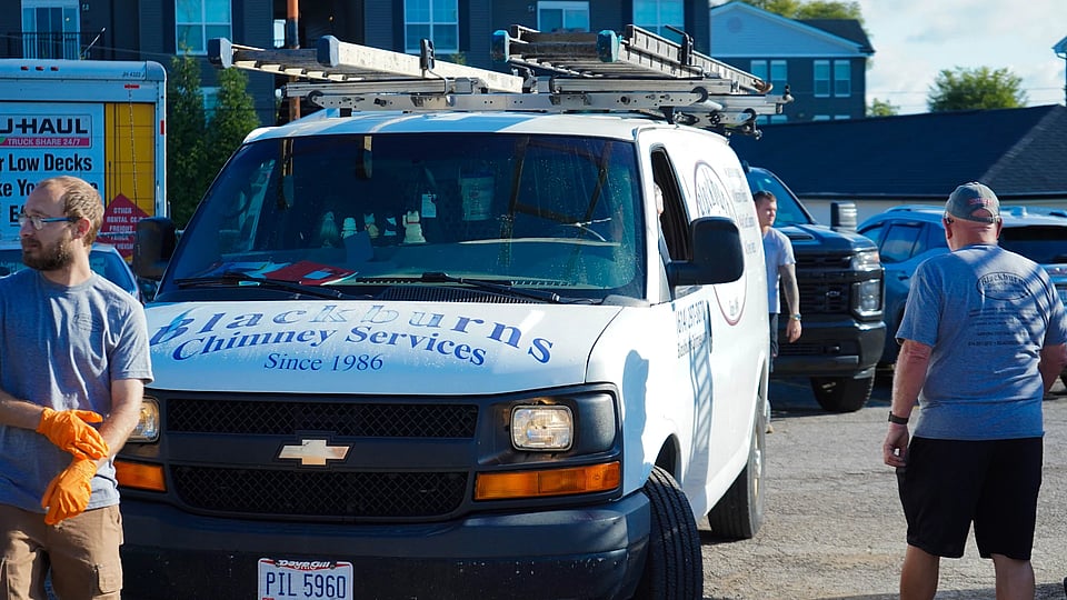 Original image of a Blackburns van with employees standing around it