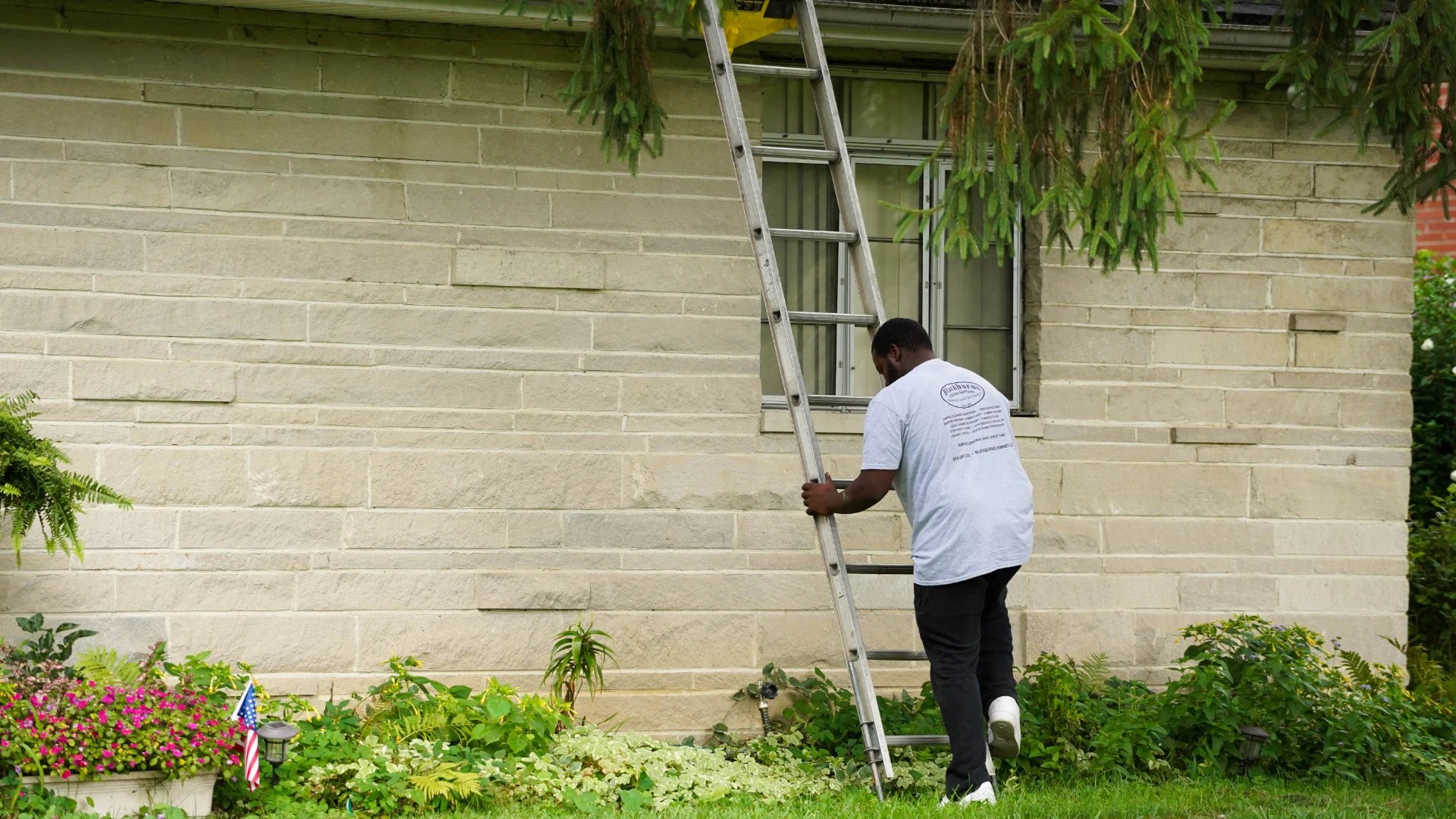 Blackburns employee ascending roof ladder