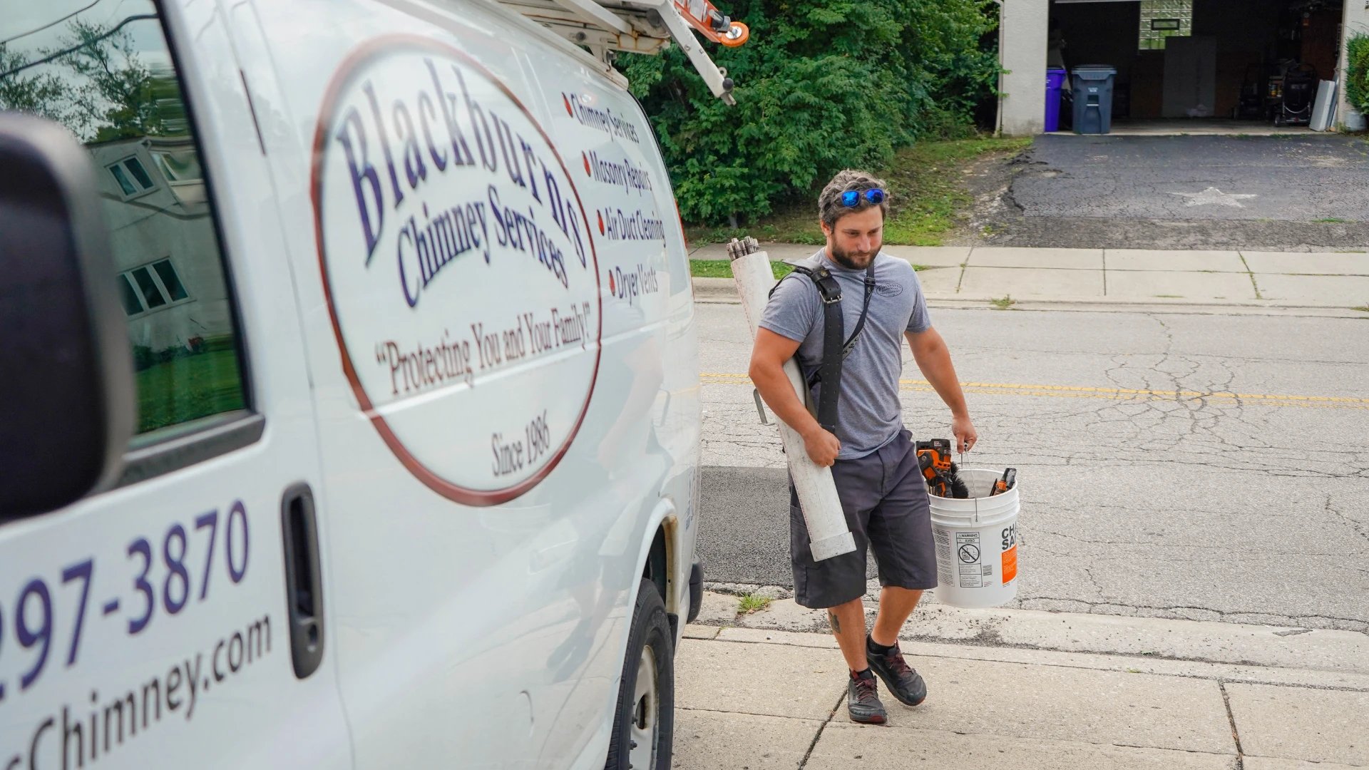 Blackburns Chimney Services employees loading equipment from work van in Columbus, OH
