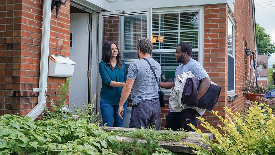 Original photo of blackburns employees greeting a homeowner before a chimney sweeping service.
