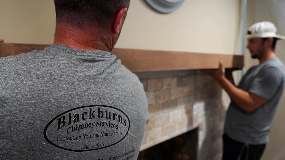 Original photo of Blackburns employees installing a new mantel