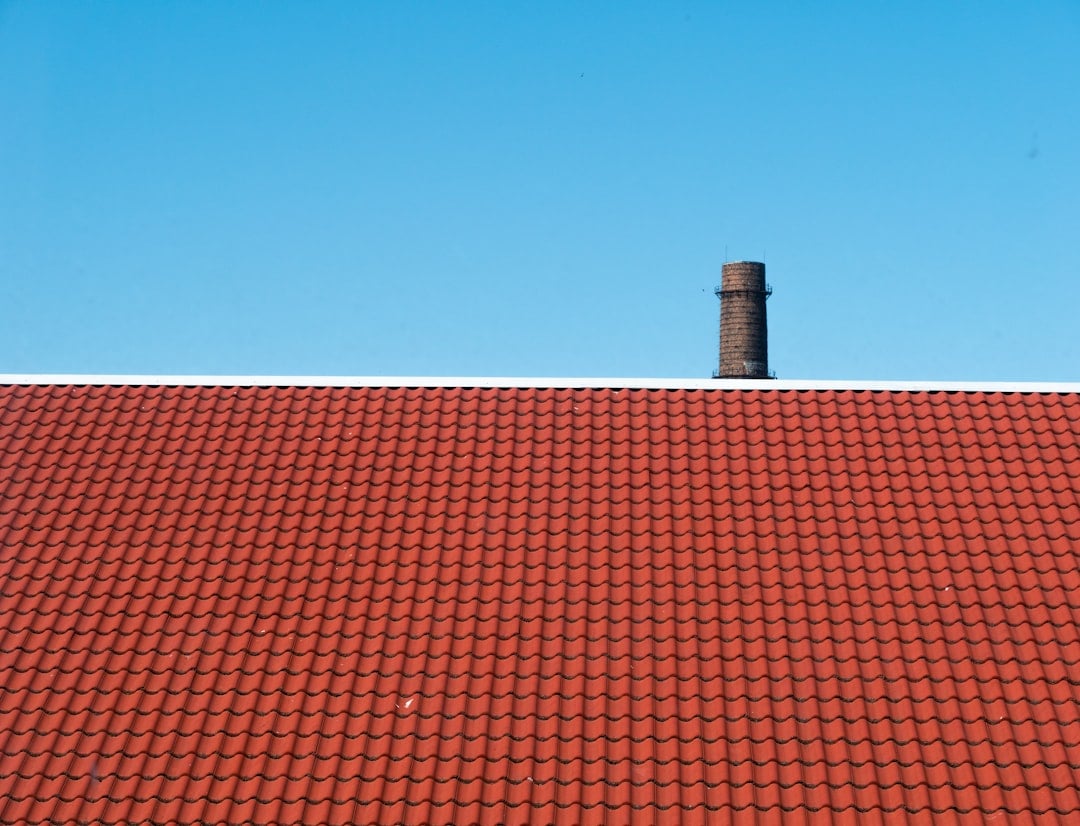 Chimney sweep technician performing a certified chimney inspection and cleaning service