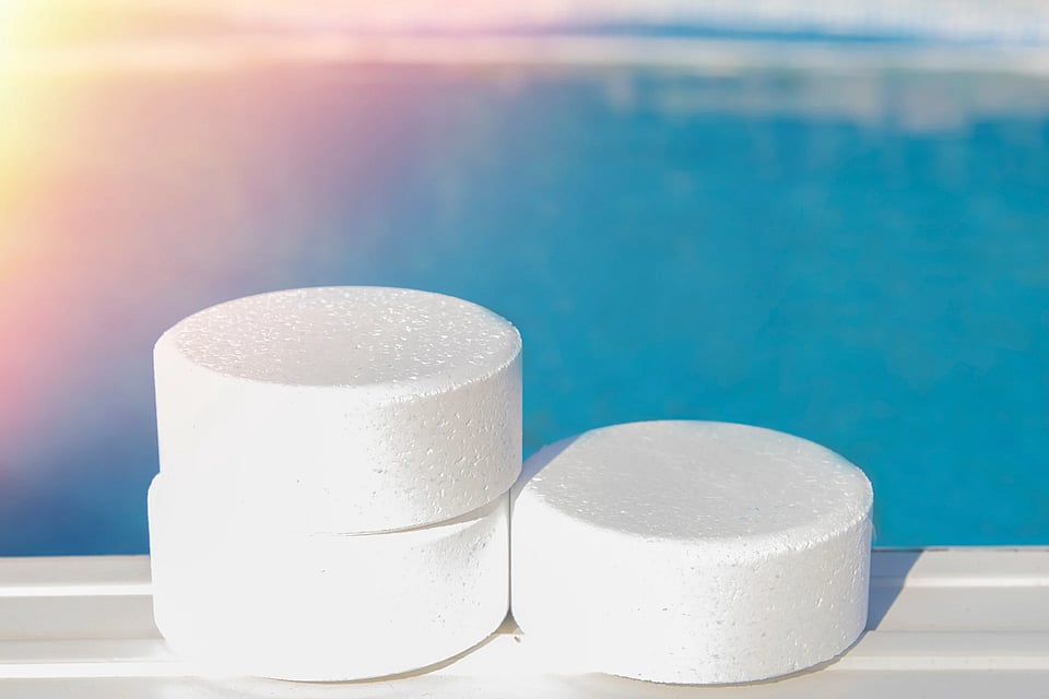 Chlorine tablets by a swimming pool.