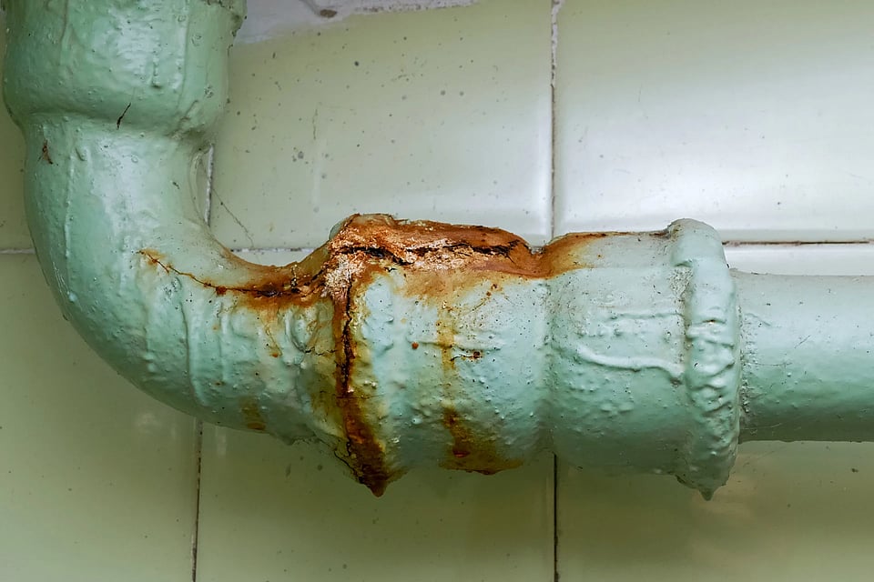 An old rusty pipe with cracks.