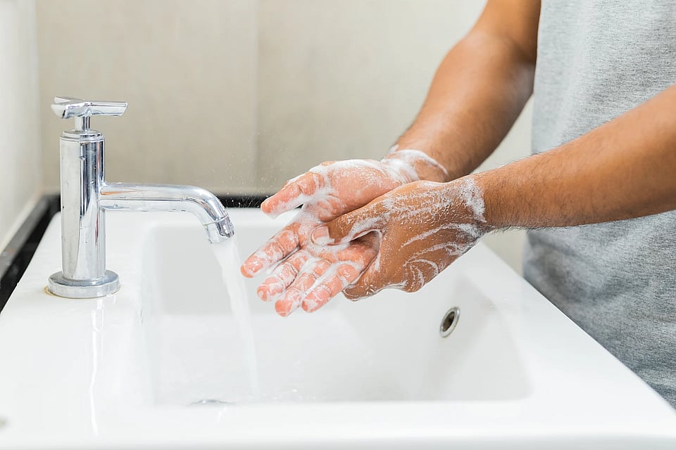 Someone using soapy water to wash their hands.