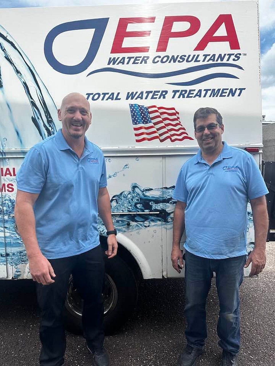 Employees of EPA Water Consultants standing beside their truck.