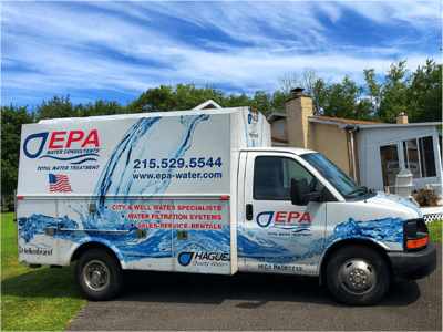 A photo of EPA Water Consultant's work truck with their logo and contact information.