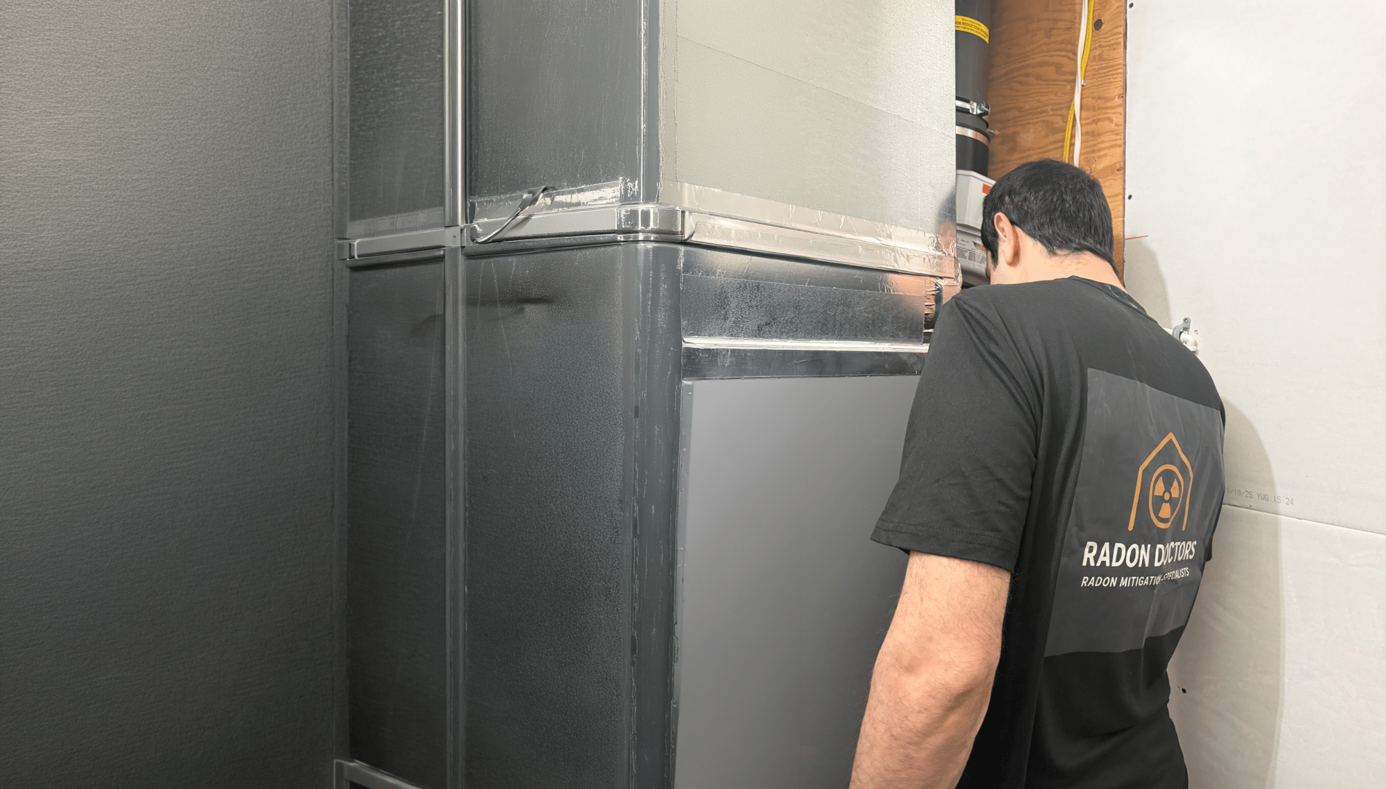 Radon testing technician inspecting a Calgary home