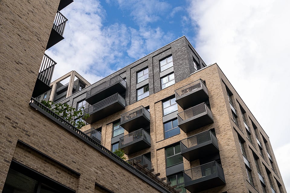 The exterior of an apartment building with balconies.