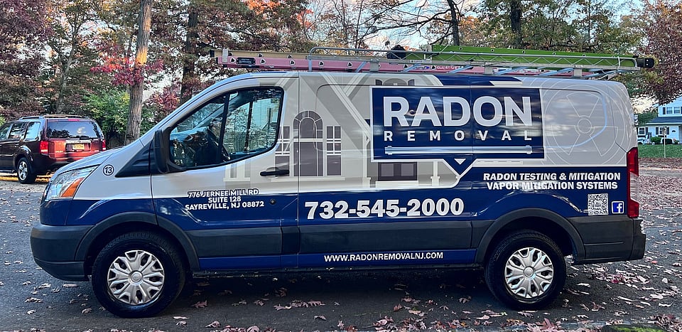 The work van for Radon Removal in New Jersey with their logo and contact information on the side.