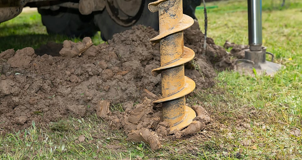 Adobe Stock image of a drill going into the ground for a well.