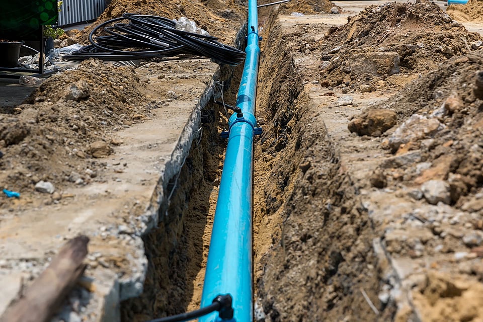 Adobe Stock image of a large pipe in a trench.