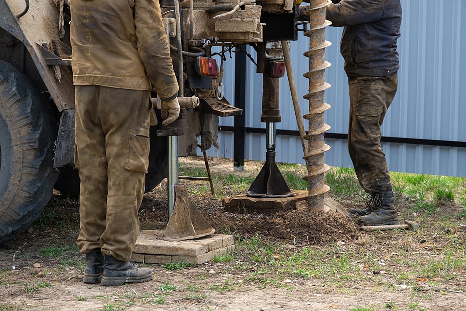 Adobe Stock image of a team drilling a whole for a well.