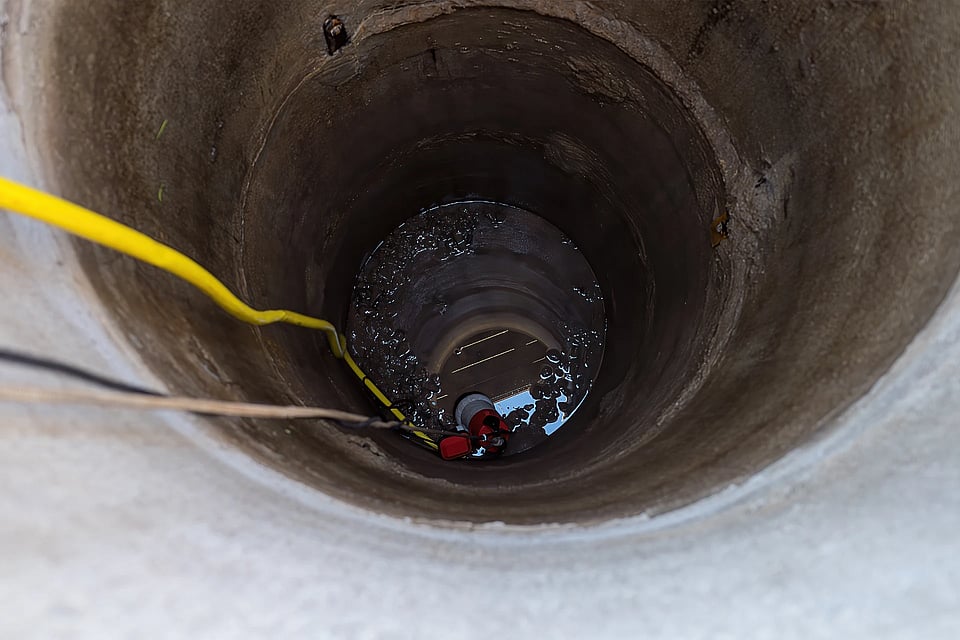 Adobe Stock image of a view looking down into a well.