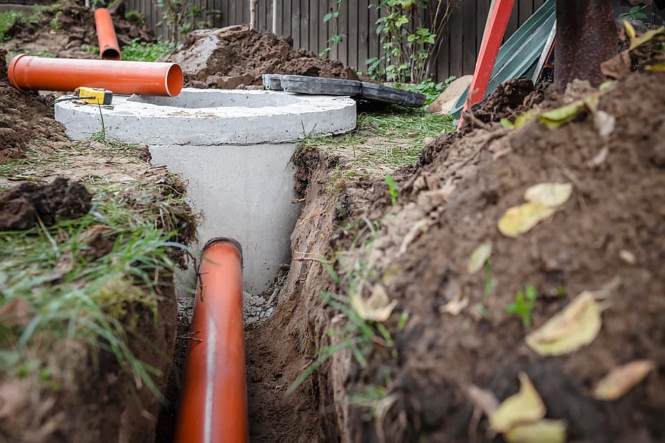 Adobe Stock image of concrete well surrounded by tools.