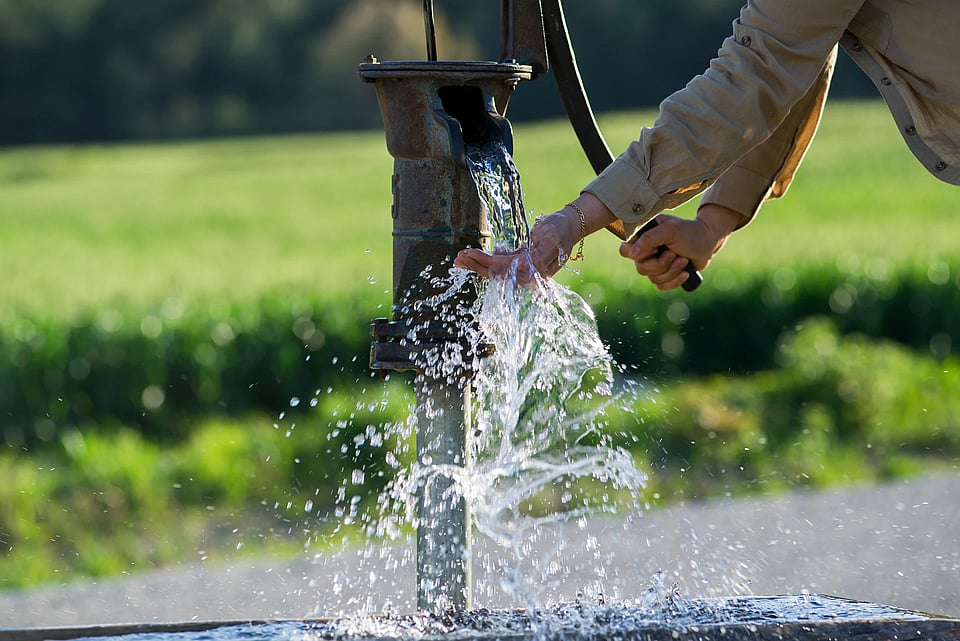 Adobe Stock image of someone pumping a hand pump.