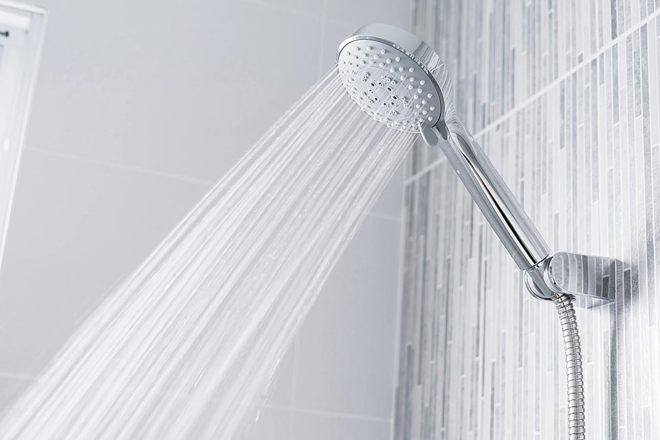 Adobe Stock image of water spraying from a shower head