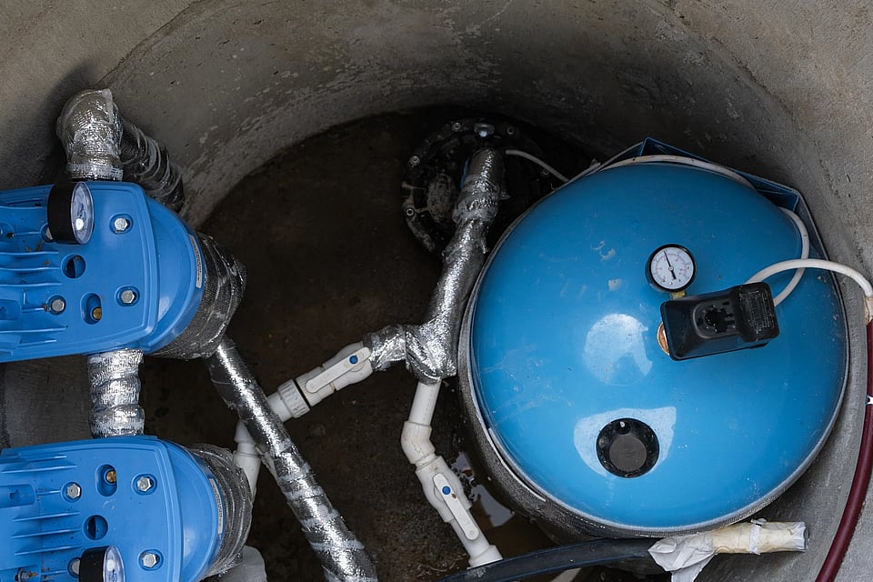 Adobe Stock image of well pumps in a well.