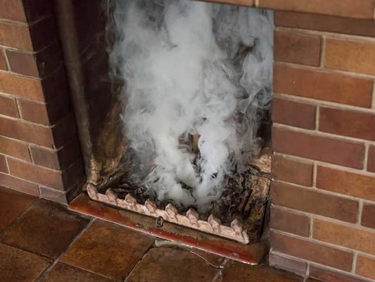 Fireplace opening filled with smoke