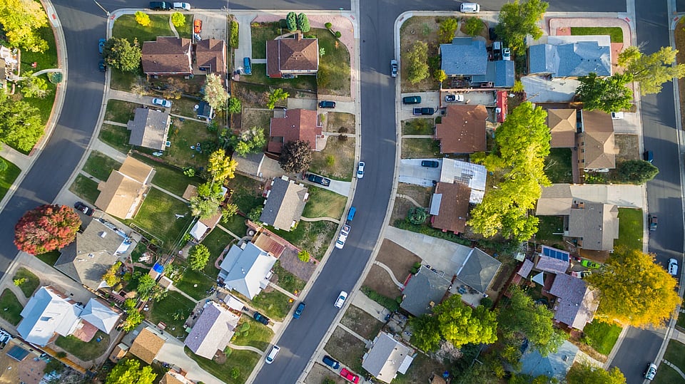 Adobe Stock image of a birds-eye view of a neighborhood with lots of homes.