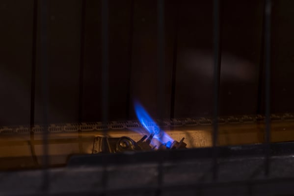 Blue pilot light on a gas fireplace