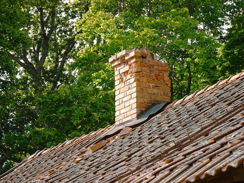Adobe Stock image of a crumbling masonry chimney.