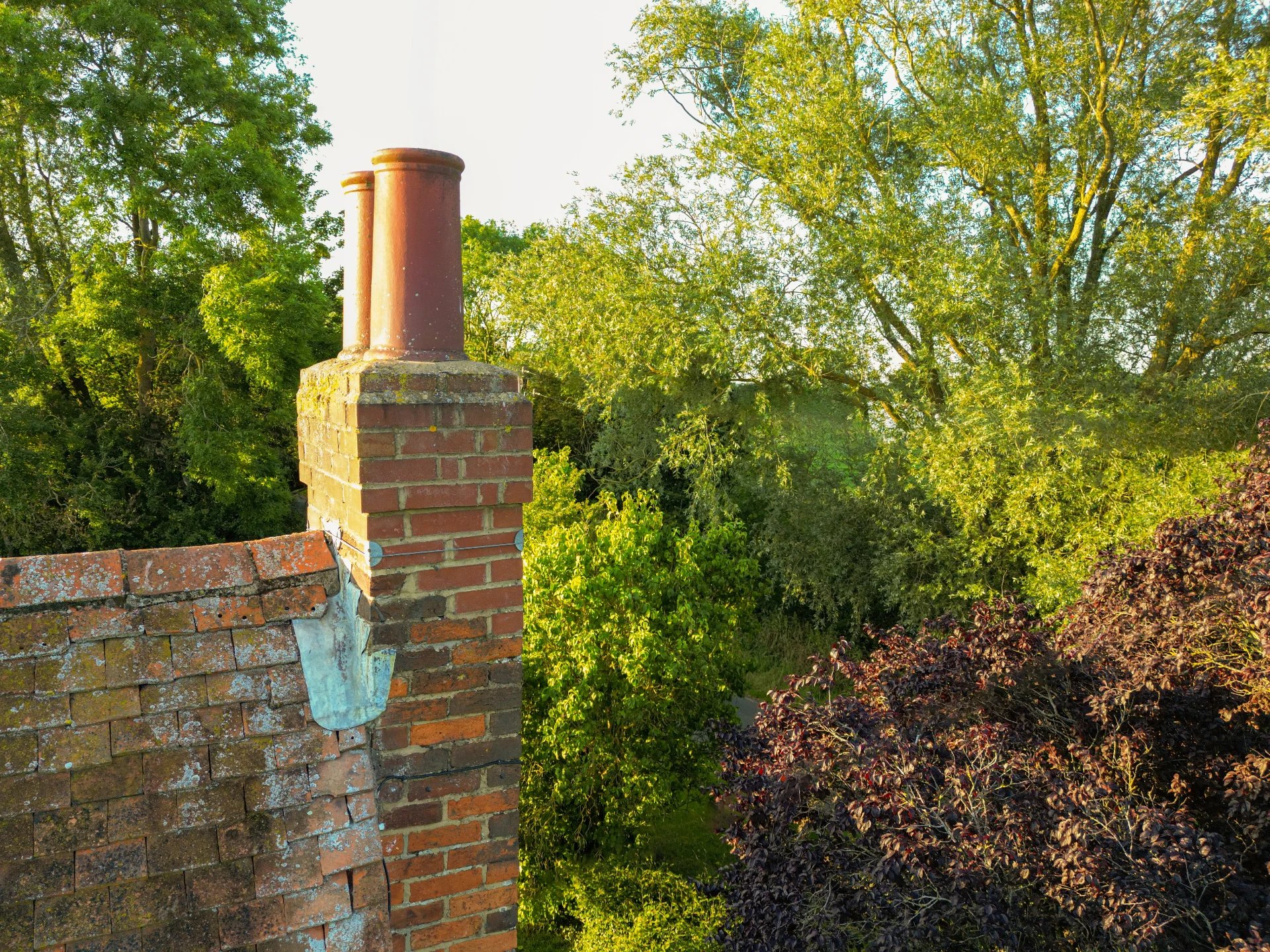 Adobe Stock image of a masonry chimney that needs repair work.