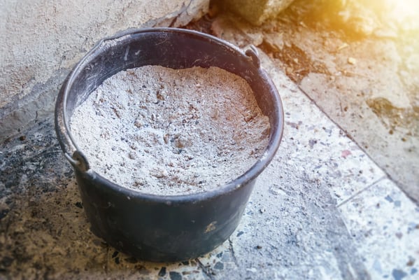 Metal bucket filled with wood ash